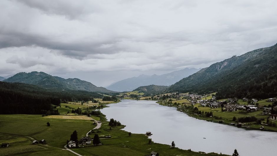 Stunning aerial view of Weißensee lake and surrounding landscape in Carinthia, Austria.